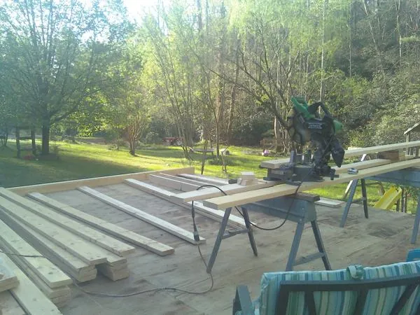 Miter saw and framing lumber on a deck under construction in Caldwell